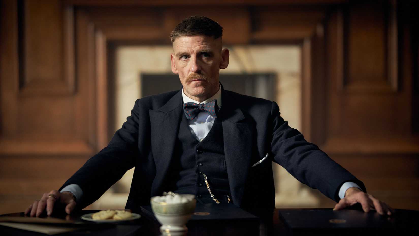 Arthur Shelby sits at a desk in Peaky Blinders