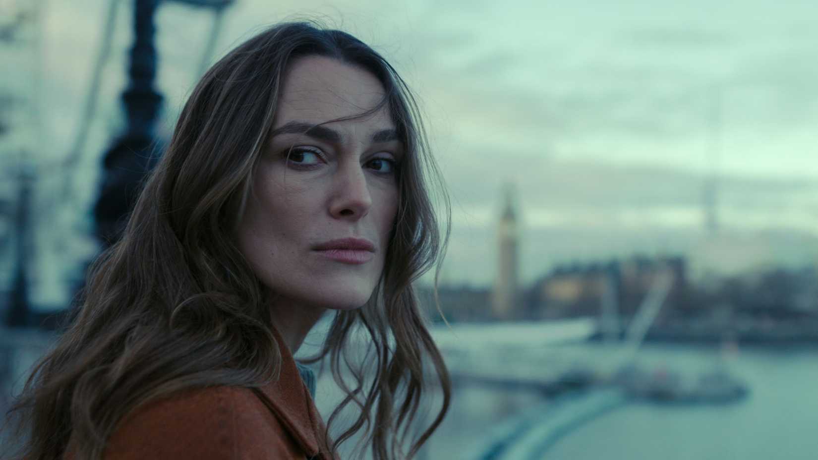 Keira Knightley looking at something in Black Doves