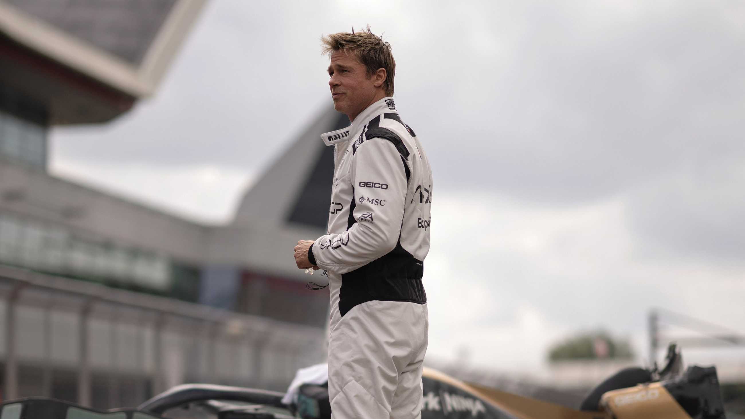 Brad Pitt looking off into the distance in his racing gear in F1