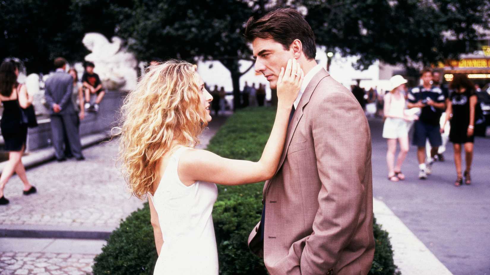 Carrie (Sarah Jessica Parker) reaching out to touch Big's (Chris Noth) cheek in Sex and the City season 2