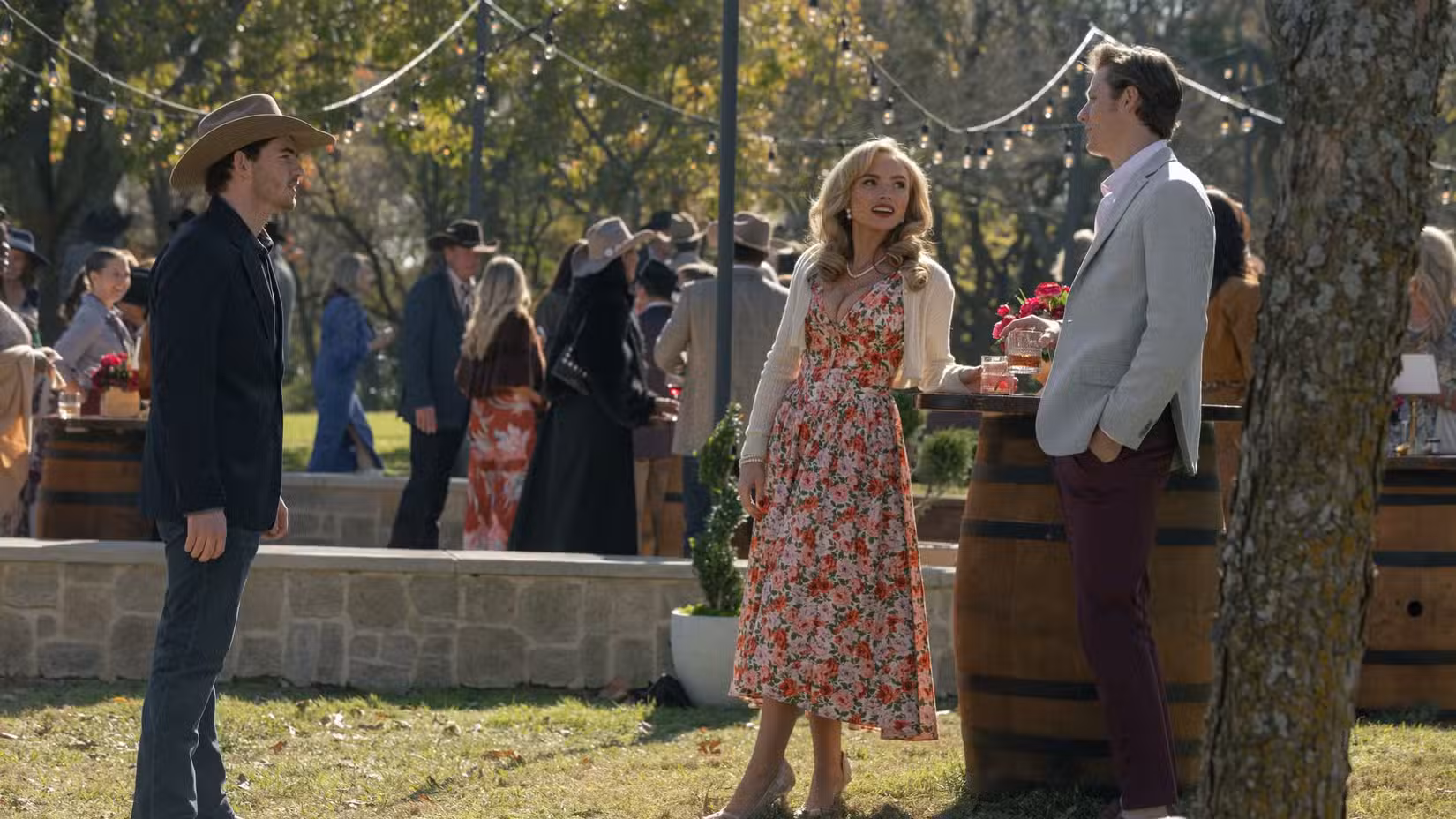 Carter (Finn Little) talking to Oreana and a handsome man at a party in Dutton Ranch