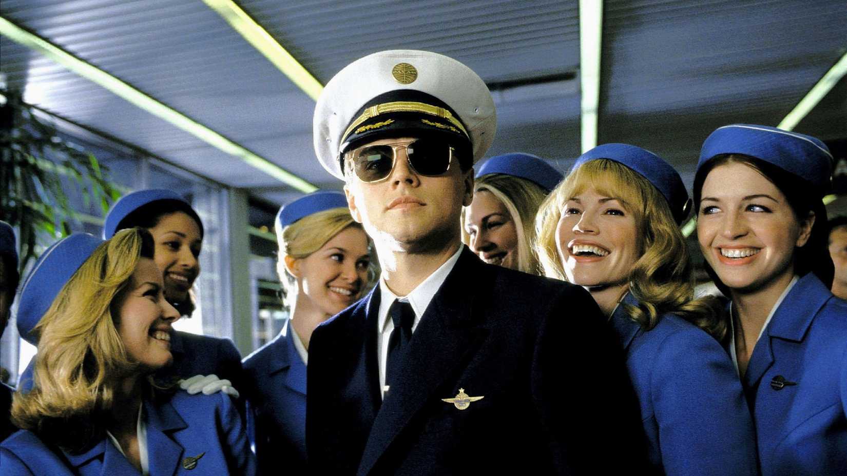 Leonardo DiCaprio wears a pilot uniform among a bunch of flight attendants in Catch Me If You Can