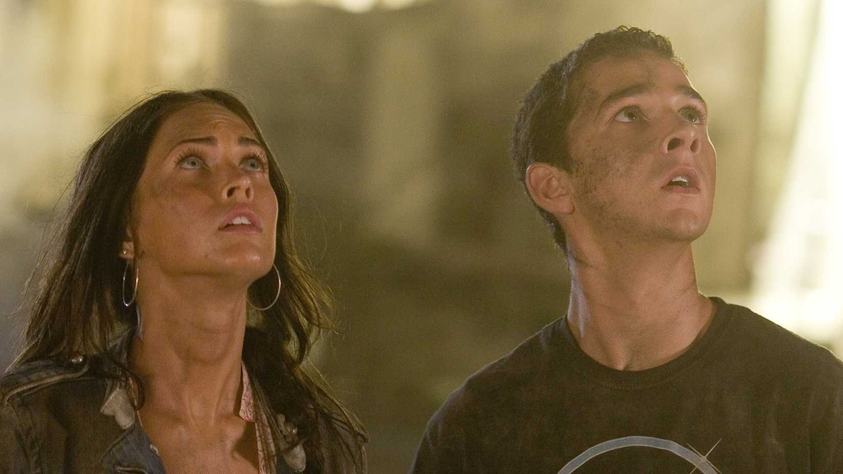 Megan Fox’s Mikaela and Shia LaBeouf’s Sam looking up at Bumblebeein Transformers
