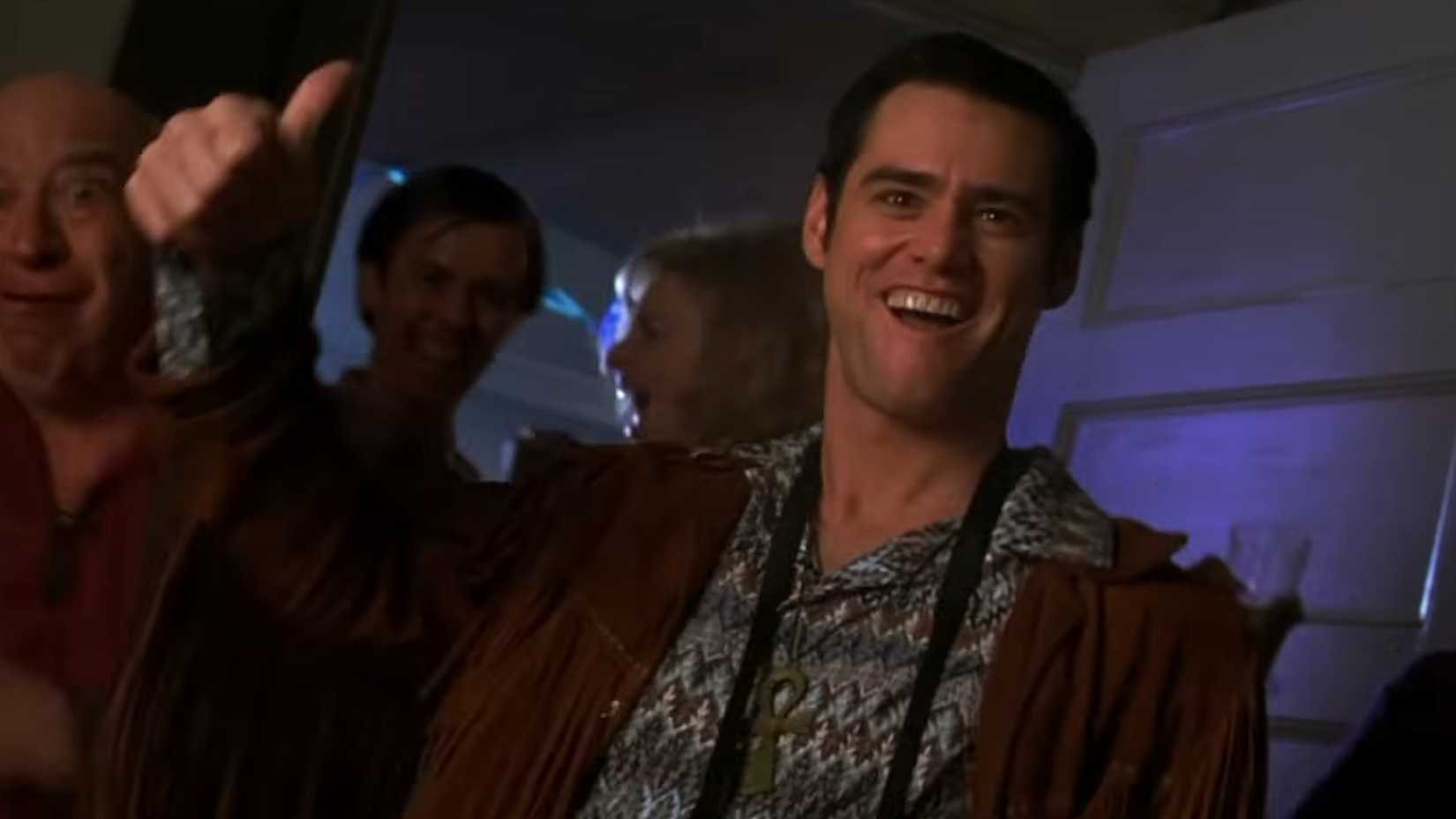 Chip (Jim Carrey) with his thumb up at a house party in The Cable Guy