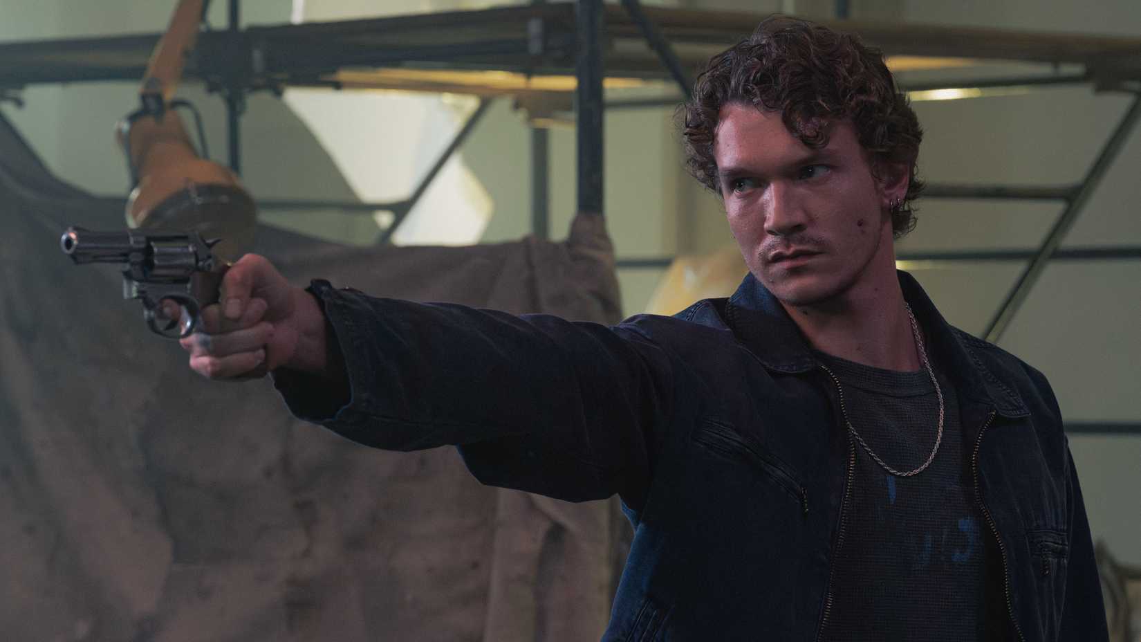 Connor Storrie's Lance Kingston holding up a gun in Criminal Minds season 19.