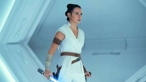 Daisy Ridley as Rey in Star Wars The Rise of Skywalker holding Anakin's lightsaber