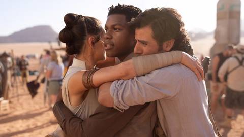 Daisy Ridley, John Boyega, and Oscar Isaac hugging on The Rise of Skywalker set
