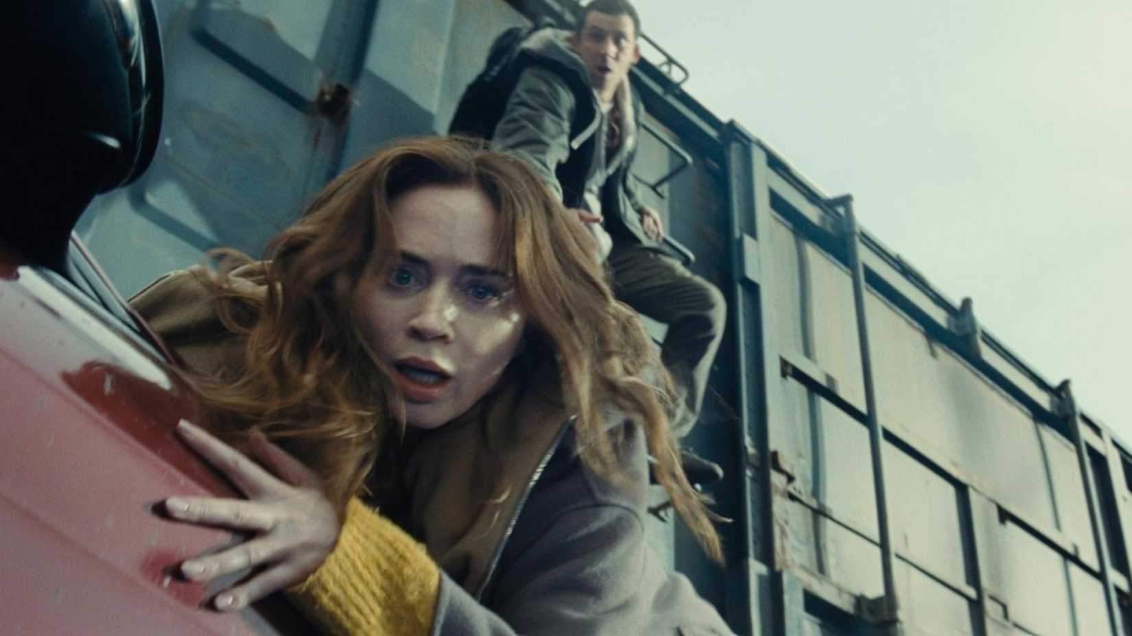 Disclosure Day (2026) train scene - Daniel (Josh O'Connor) and Margaret (Emily Blunt) jumping from the car to the train