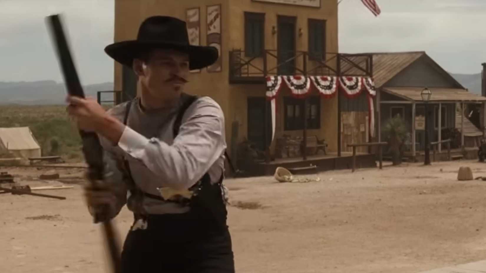 Doc (Val Kilmer) firing a shotgun in the air to scare a horse in Tombstone