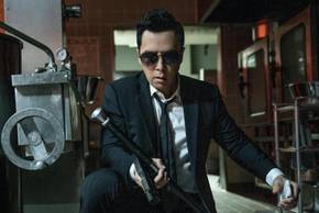 Donnie Yen's Caine crouched down in a kitchen with his walking stick held out