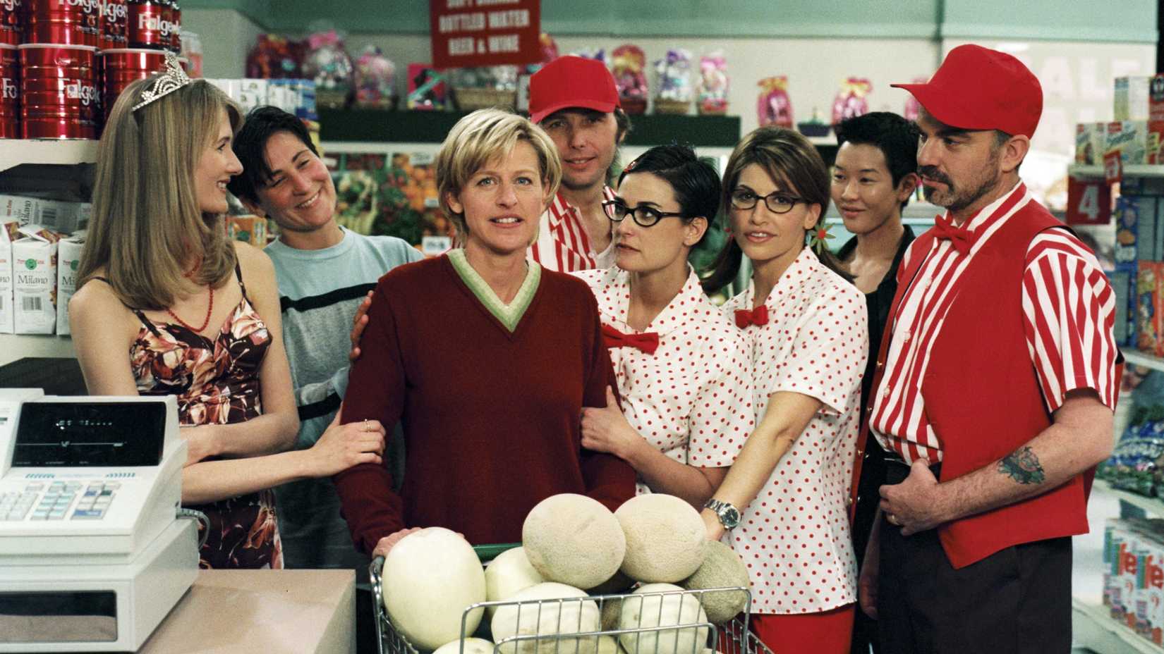Ellen Degeneres surrounded by Laura Dern, KD Lang, Dwight Yoakam, Demi Moore, Gina Gershon, Jenny Shimizu, and Billy Bob Thornton