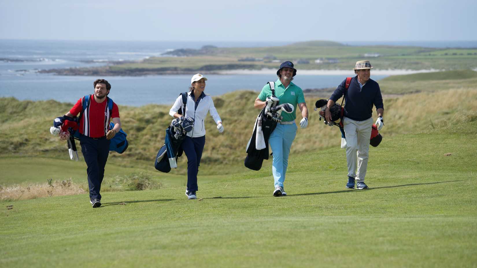 Frankie, Marie, Freddy and Teddy walking with their golf bags in Finnegan's Foursome