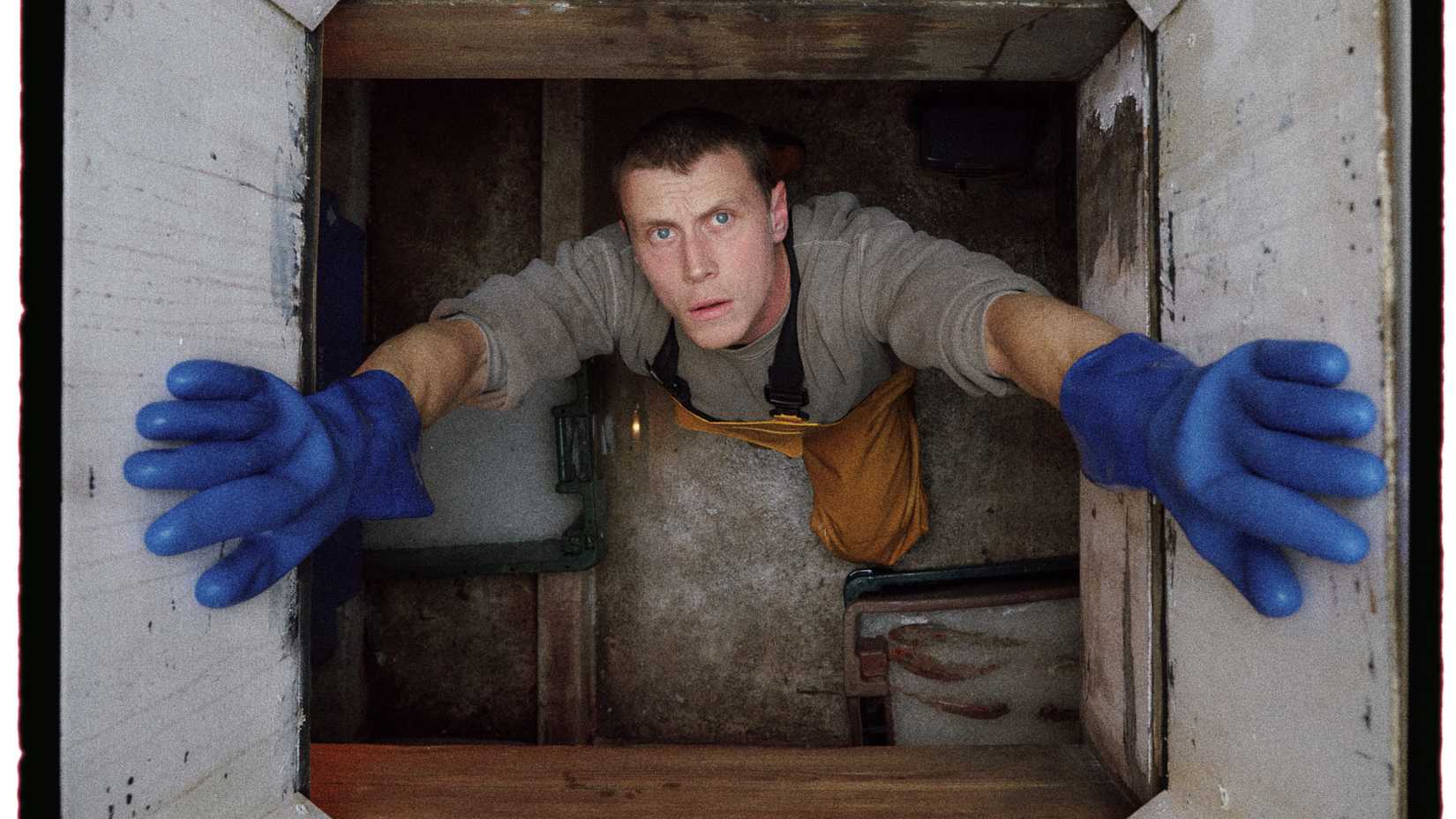 George MacKay staring up from inside the fishing boat in Rose of Nevada