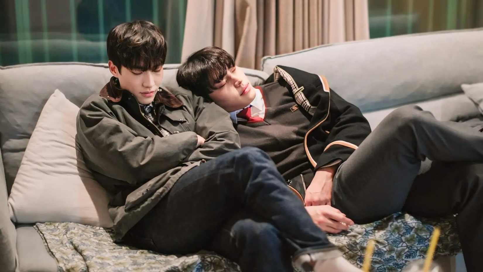Two men nap together on a couch in the K-drama Gray Shelter.
