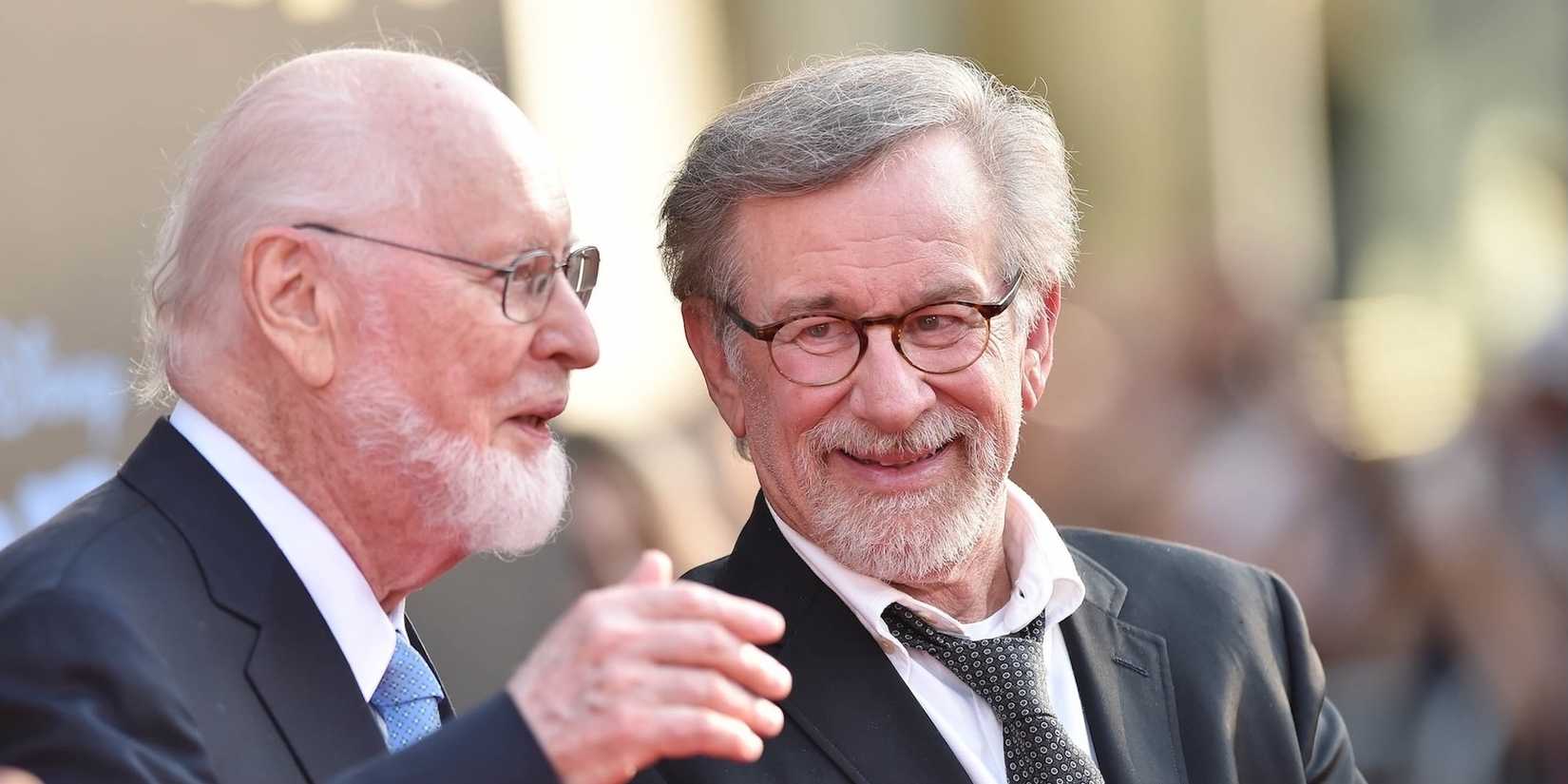 John Williams and Steven Spielberg speaking with each other at the premiere of Disney's The BFG at the El Capitan Theatre in Los Angeles.