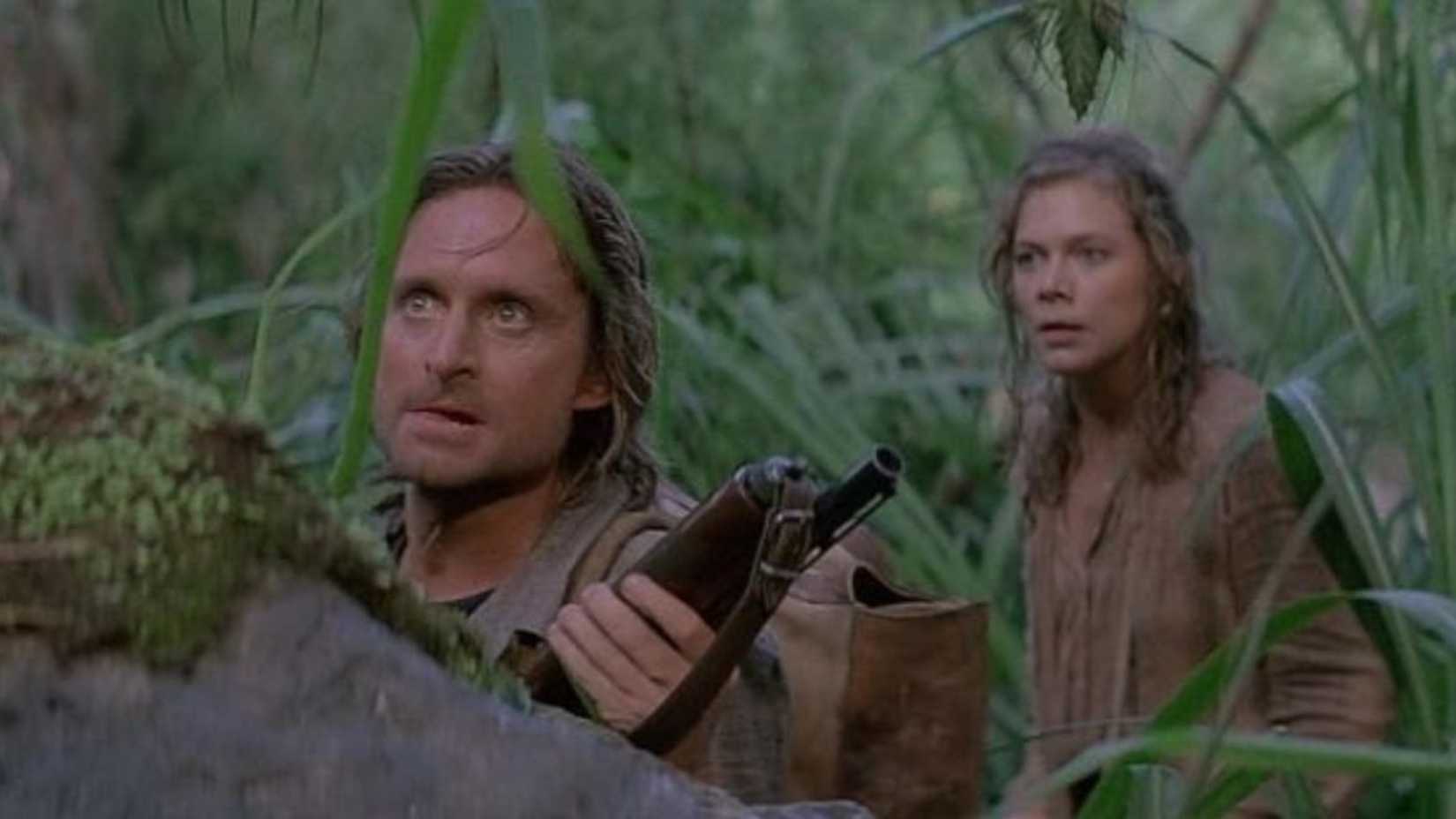 Jack (Michael Douglas) with Joan (Kathleen Turner) treking through the jungle in Romancing the Stone