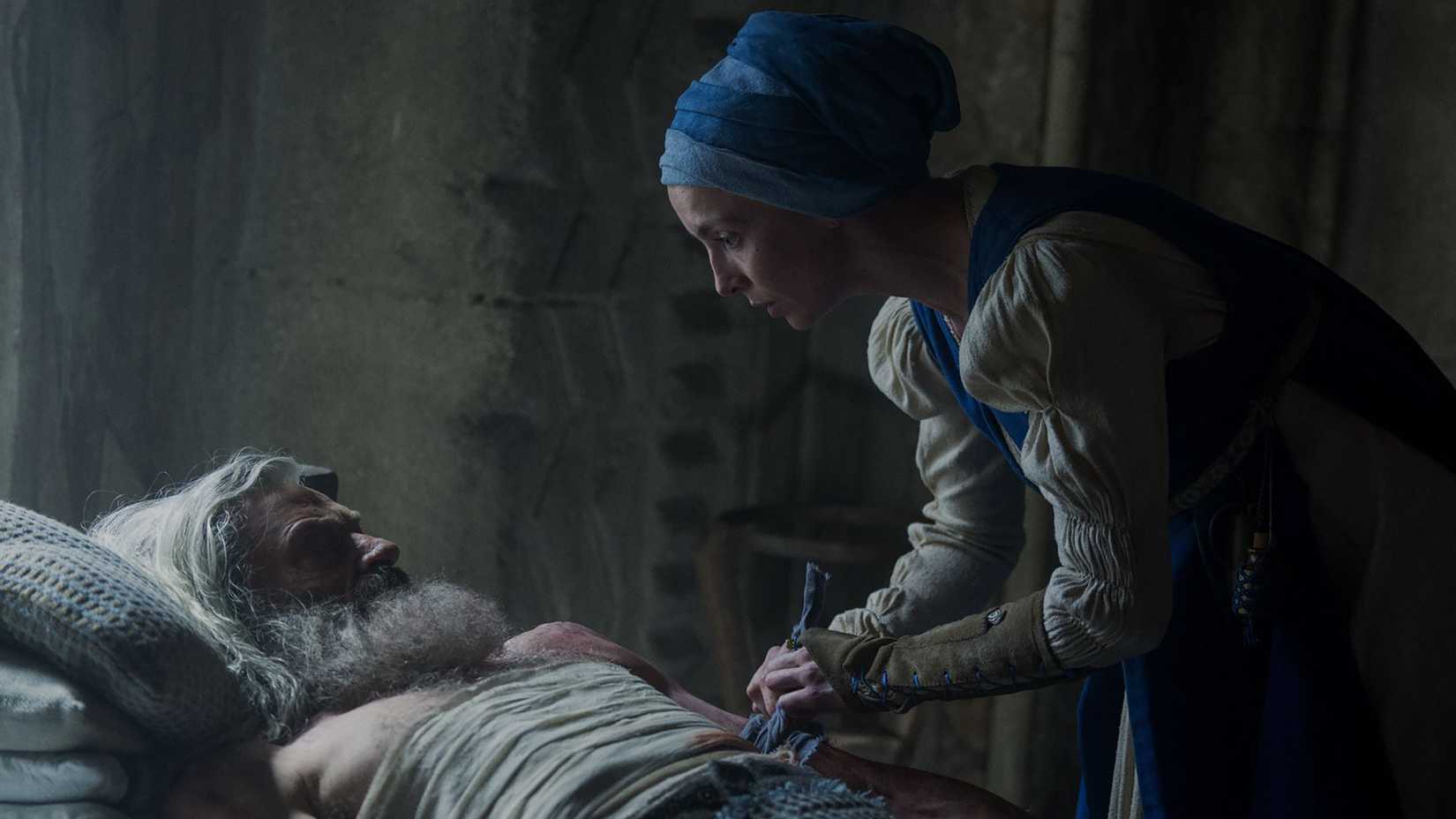 Jodie Comer's Sister Brigid tending to Hugh Jackman's Robin while in bed in The Death of Robin Hood