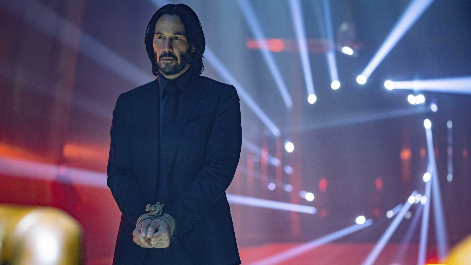 Keanu Reeves as John Wick with his hands bound in John Wick: Chapter 4