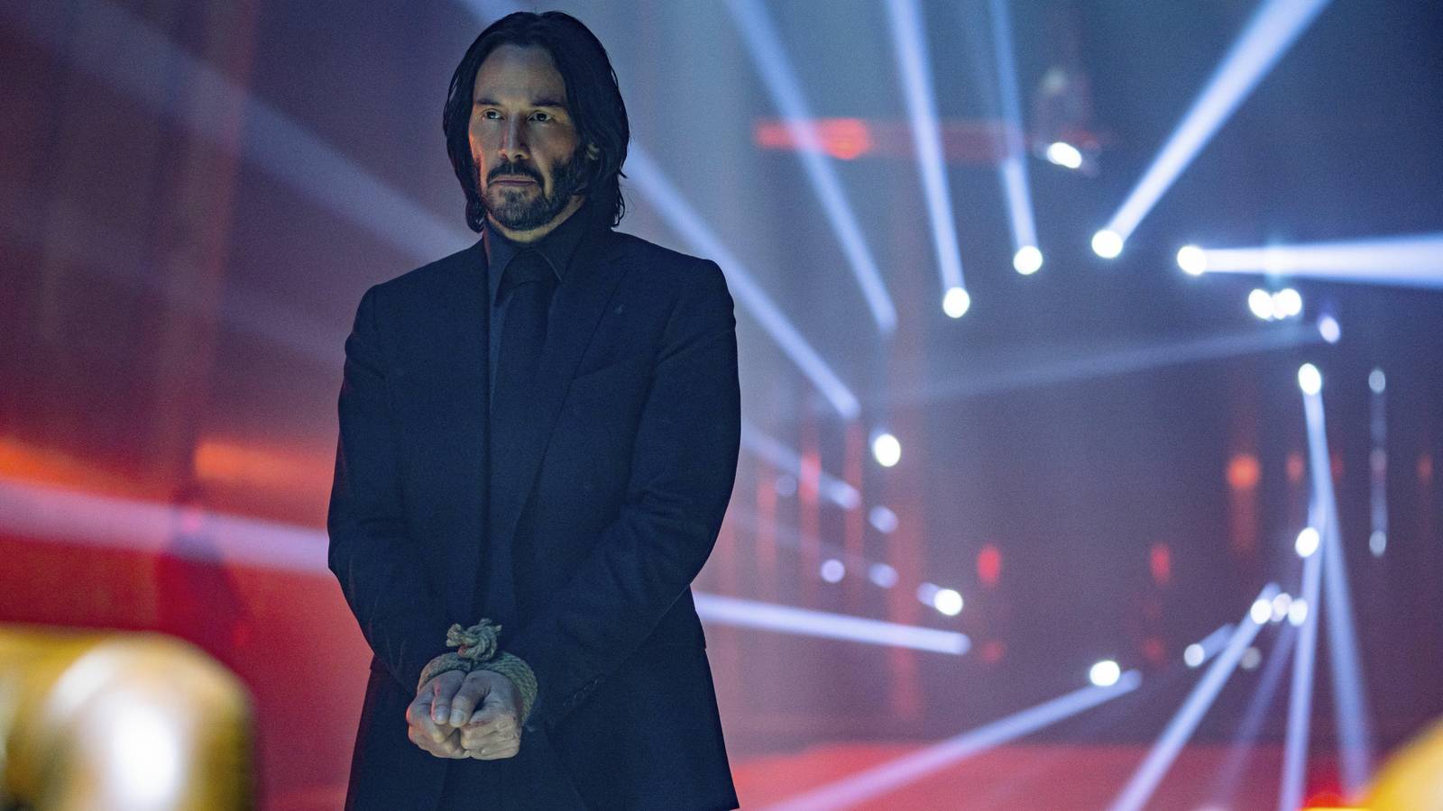 Keanu Reeves as John Wick with his hands bound in John Wick: Chapter 4