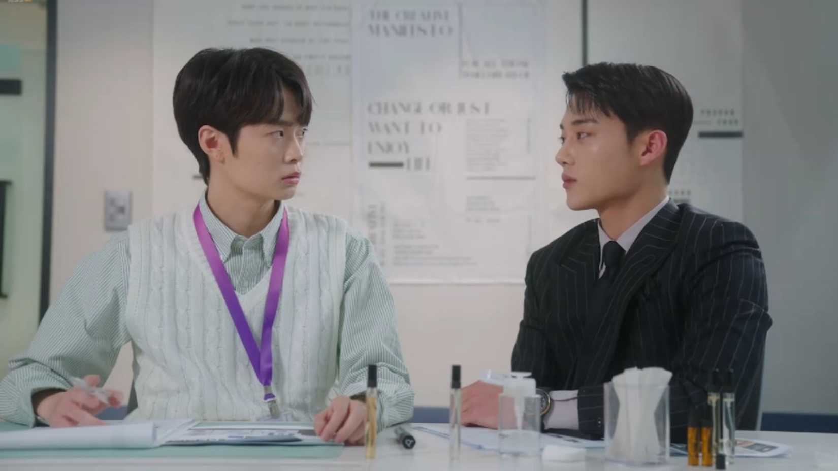 Two coworkers stare at each other in the K-drama Jun & Jun.
