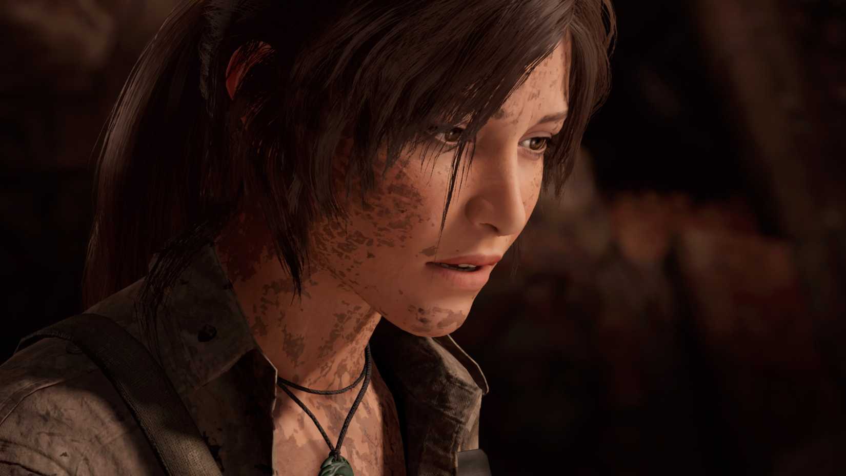Lara Croft has dirt on her face while looking to the side in Shadow of the Tomb Raider
