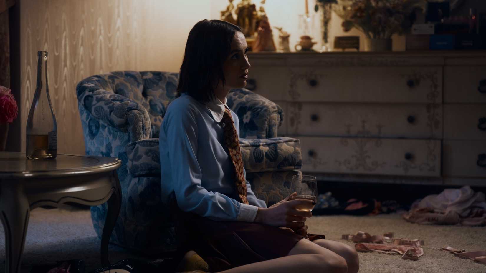 Lexi (Maude Apatow) sitting on the floor with a glass of wine in Euphoria season 3 finale