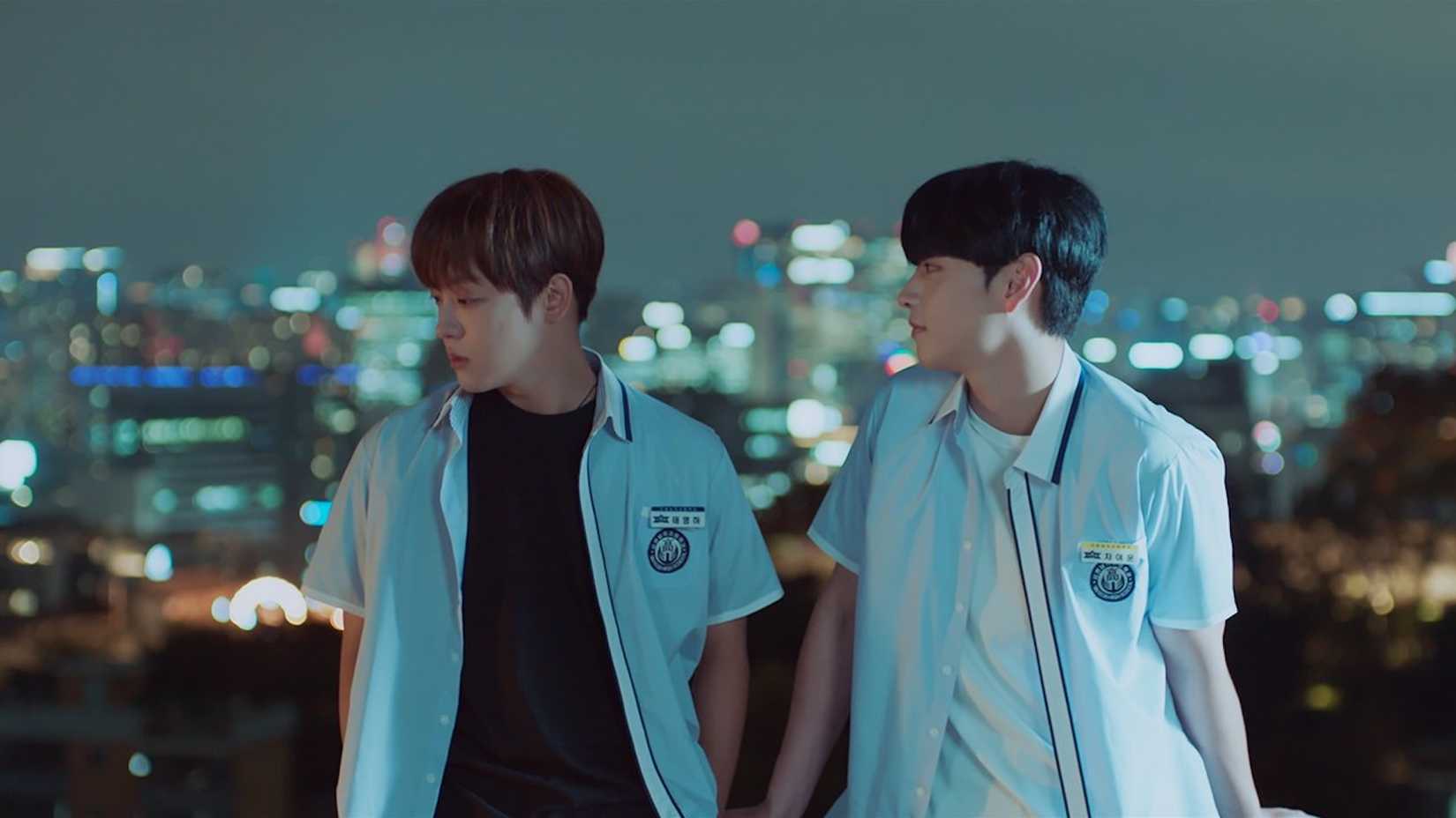 Two students in front of a cityscape at nighttime in the K-drama Love For Love's Sake.