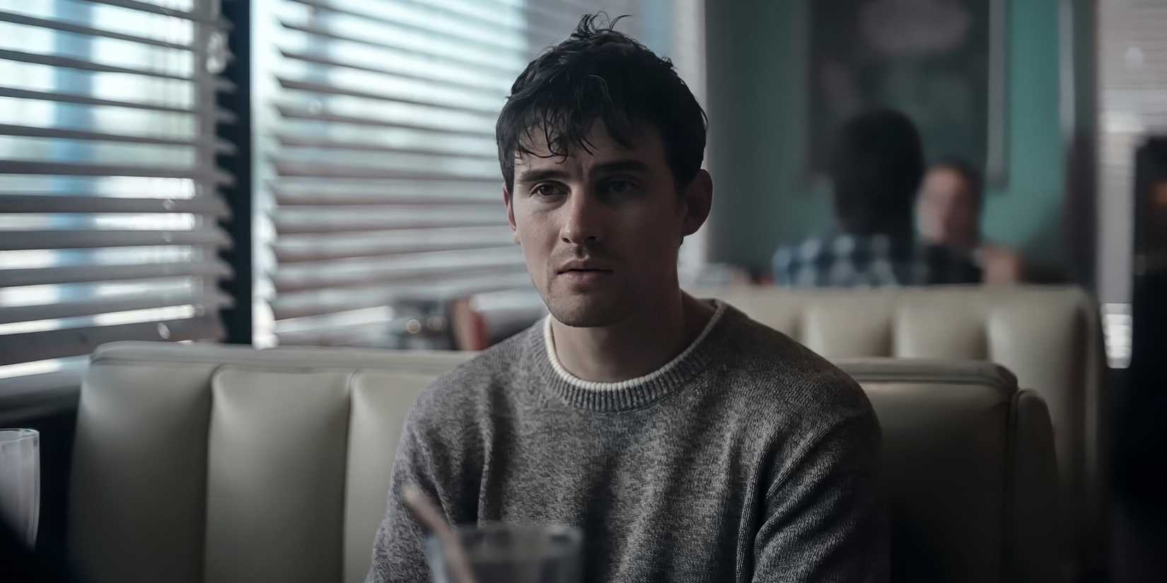 Michael Johnston as Bear sitting at a booth in a diner in Obsession.