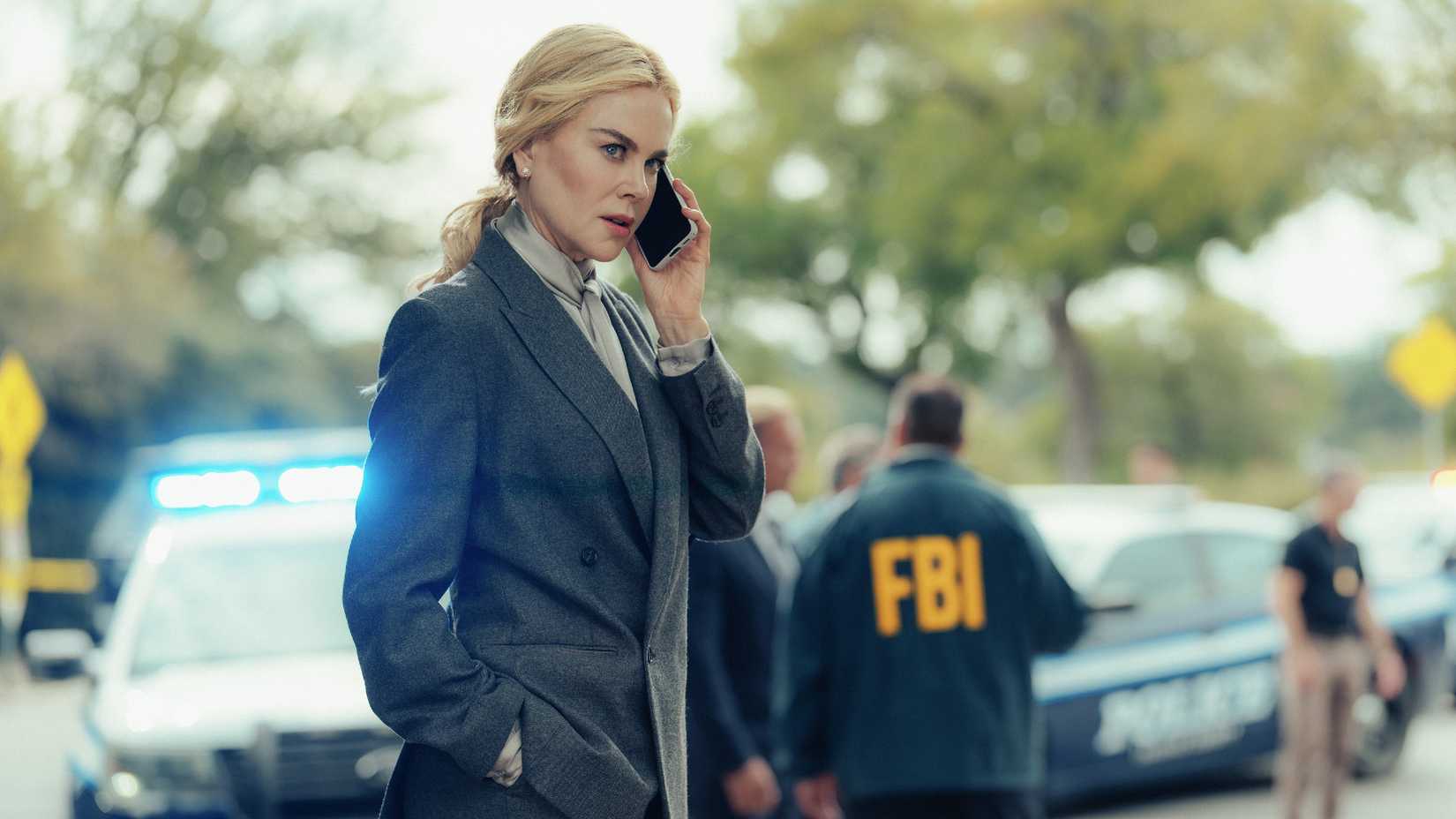 Nicole Kidman stands on the phone with FBI agents in the background in Lioness season 3
