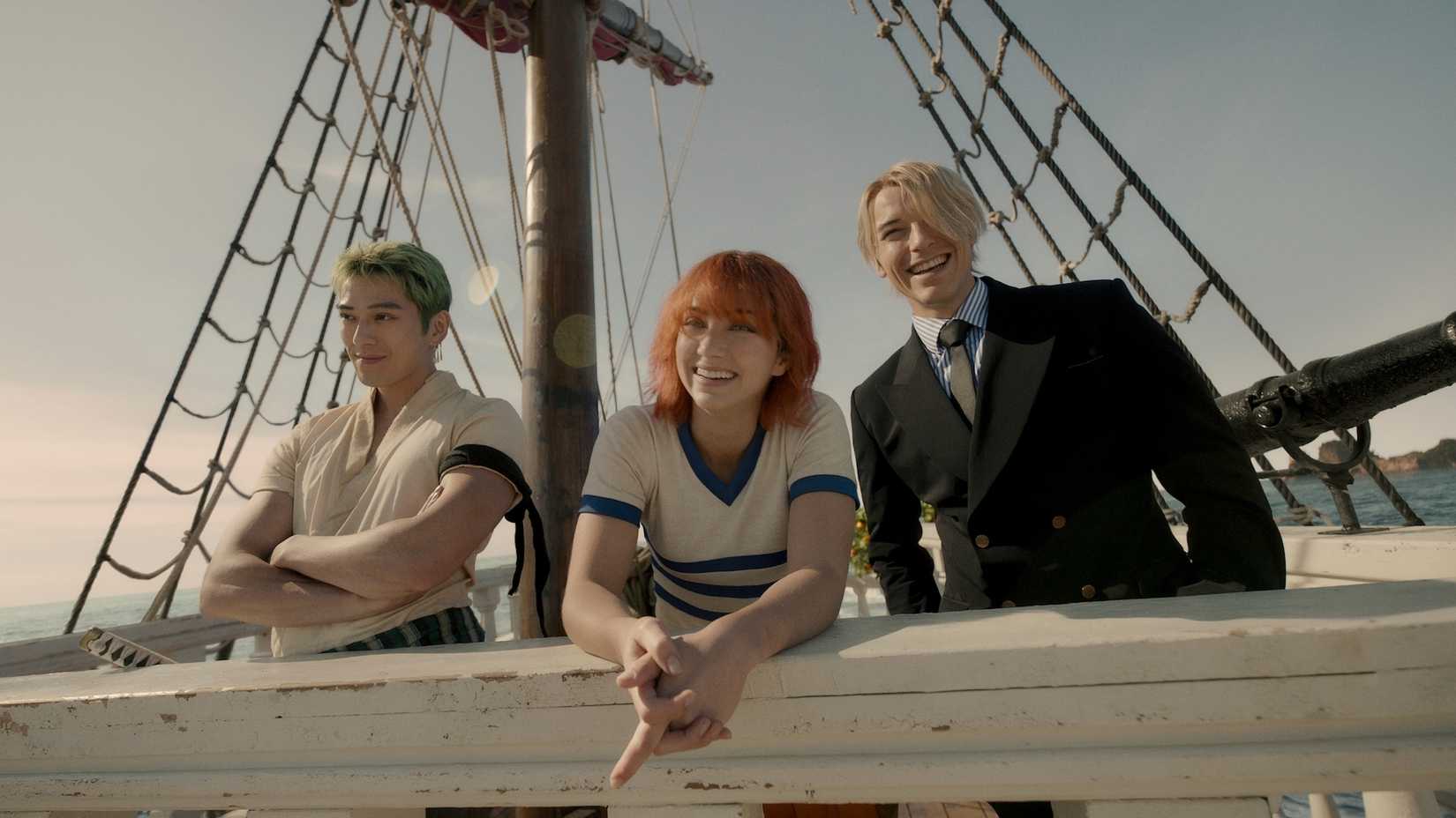 Zoro, Nami and Sanji look happy as they stand on the deck of the Going Merry