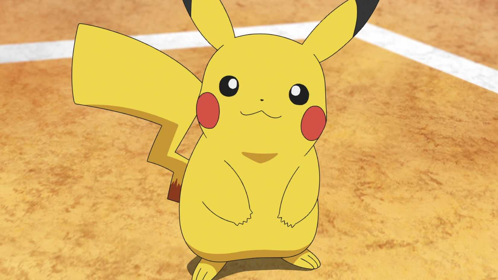 Pikachu smiling while standing in an arena in the Pokemon anime.