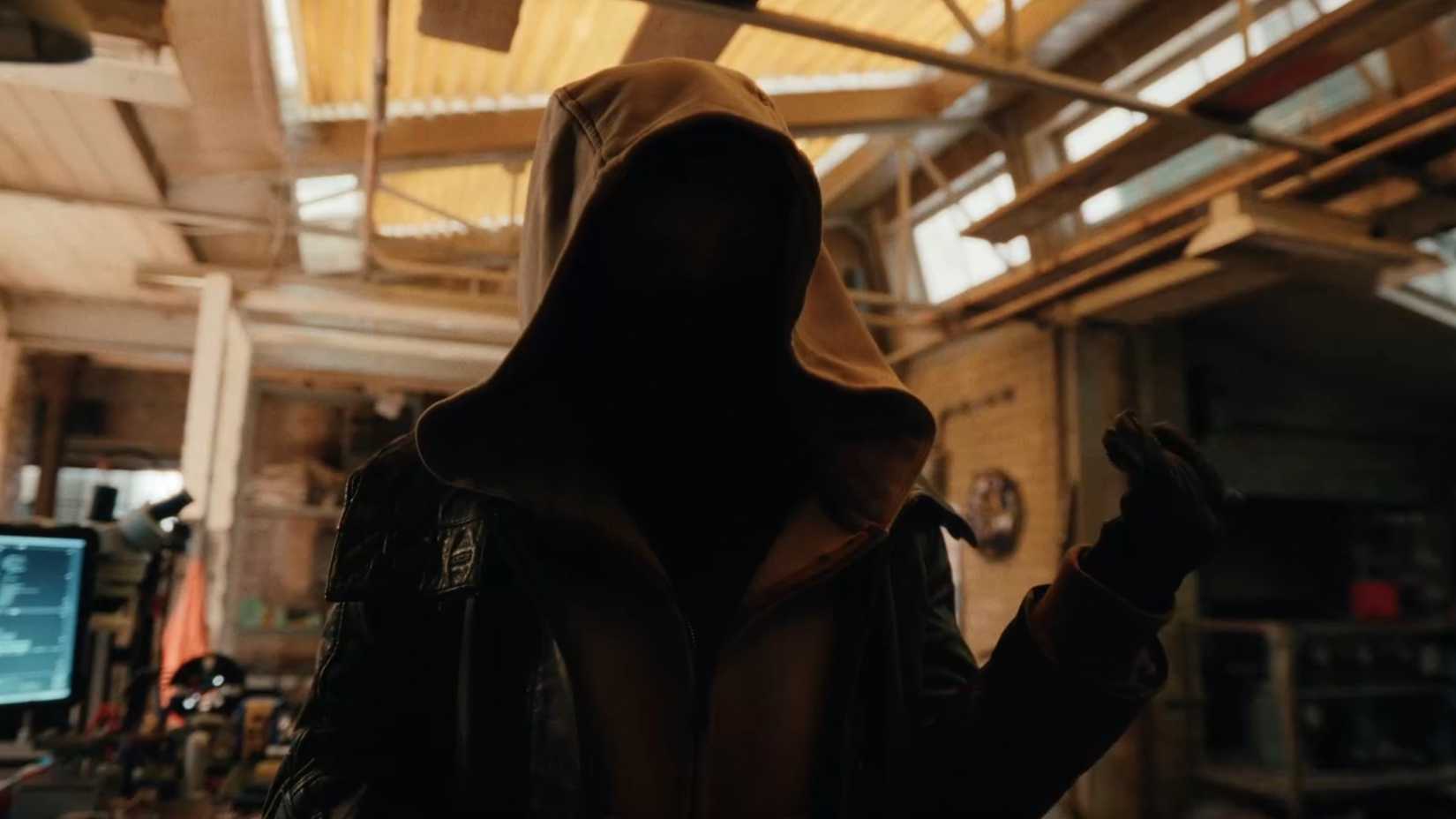 Sadie Sink's character wears a hoodie shrouding her face while putting her hand up in the Spider Man Brand New Day Trailer