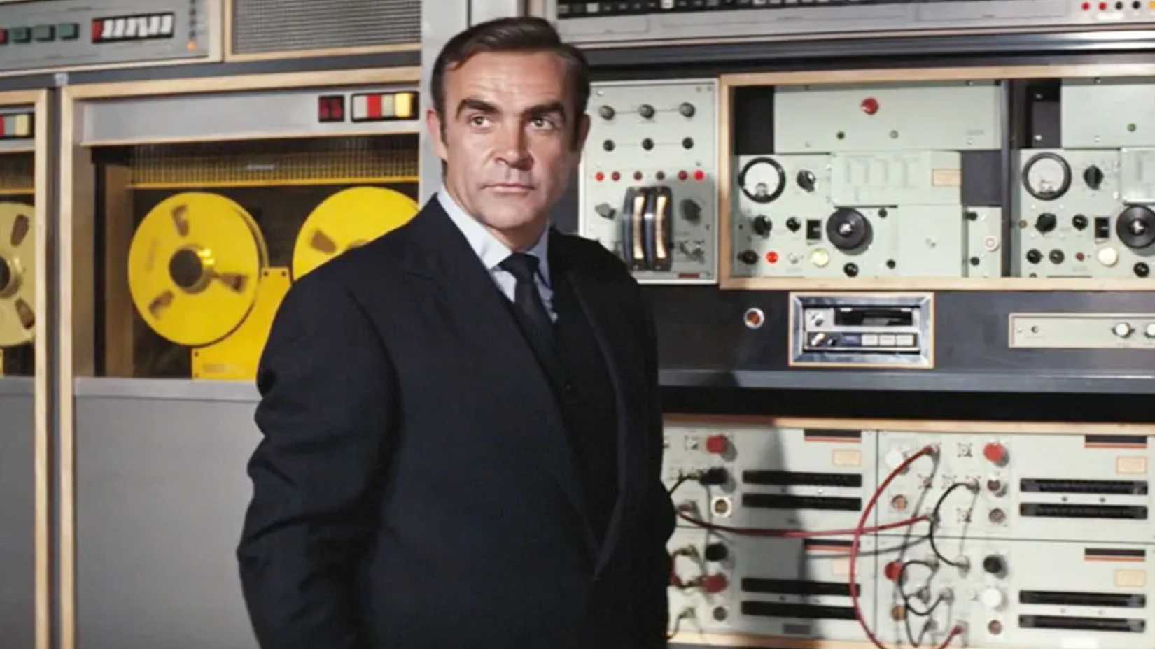 sean connery's james bond stands by a supercomputer