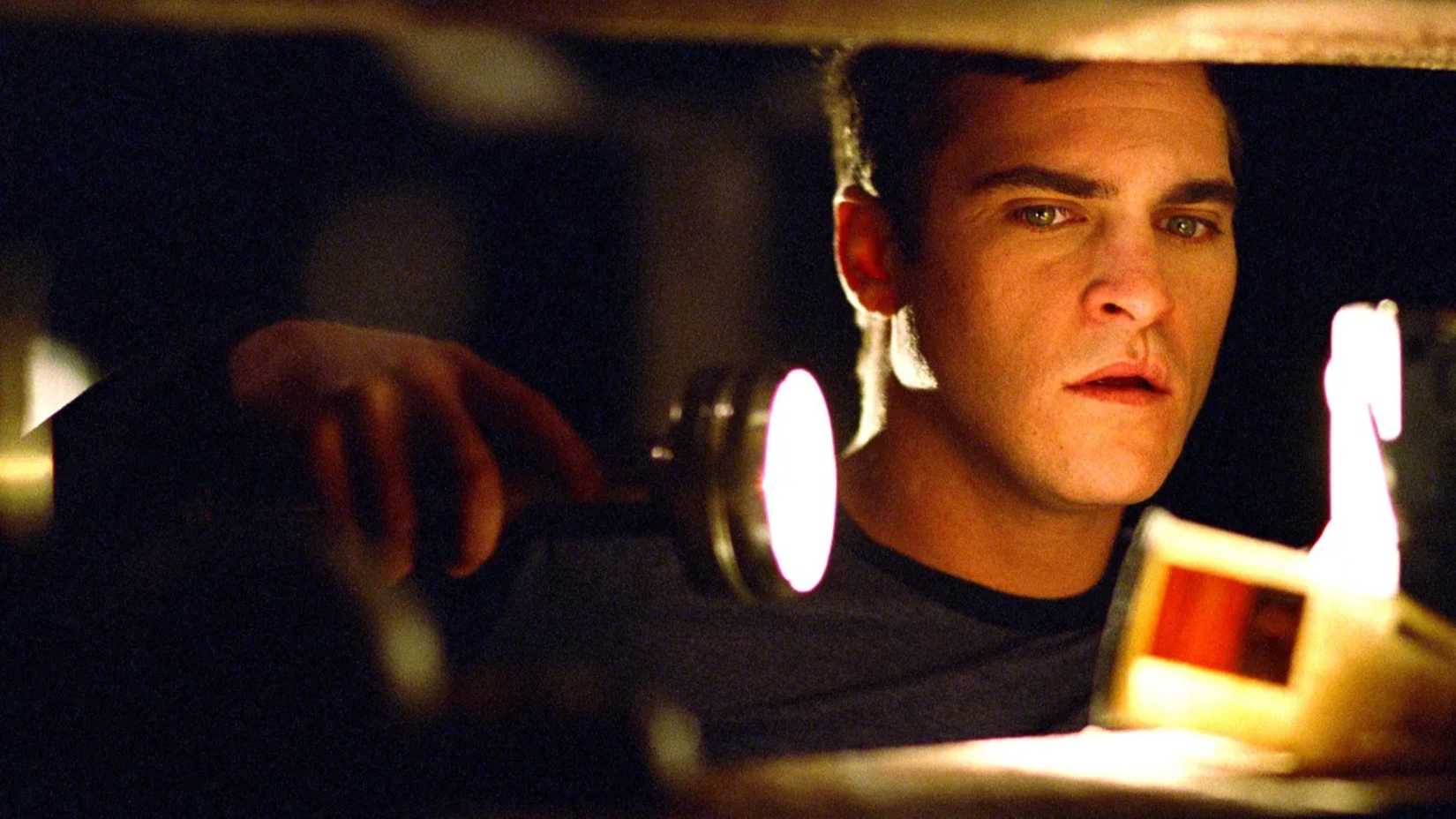 Joaquin Phoenix holds a flashlight in Signs 