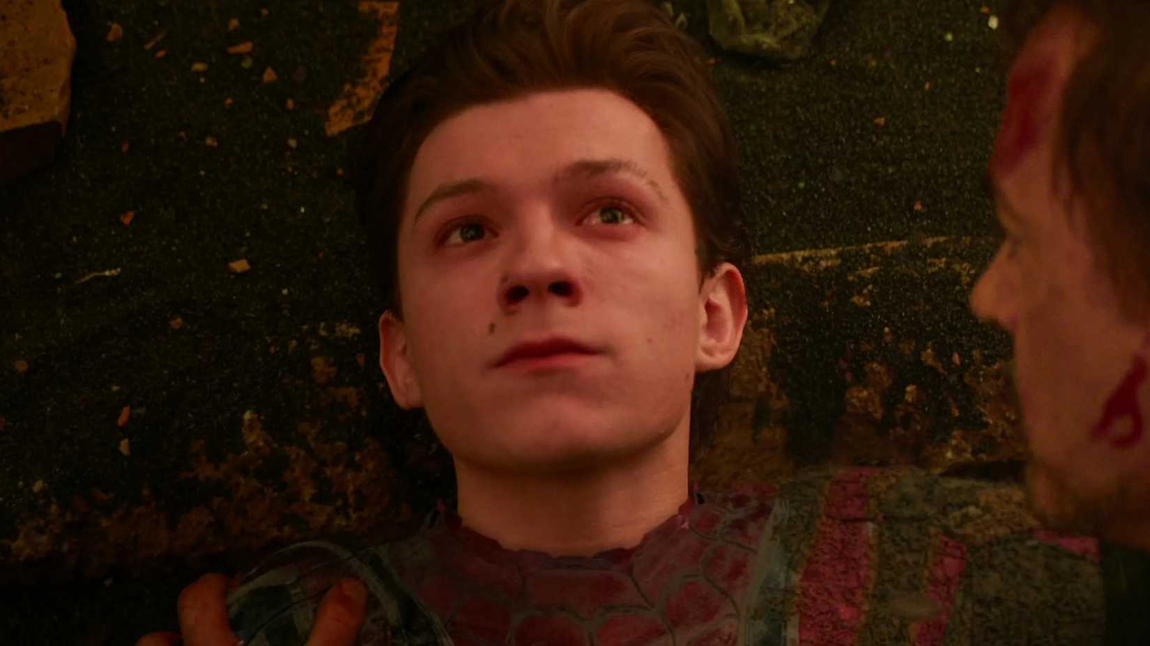 Spider-Man looking up with Tony Stark looking at him in the end of Avengers Infinity War