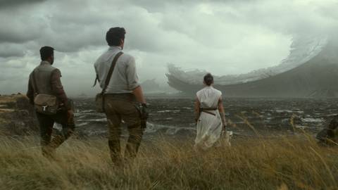 Finn, Poe, and Rey approach the ruin of the Death Star in Star Wars: Episode IX - The Rise of Skywalker