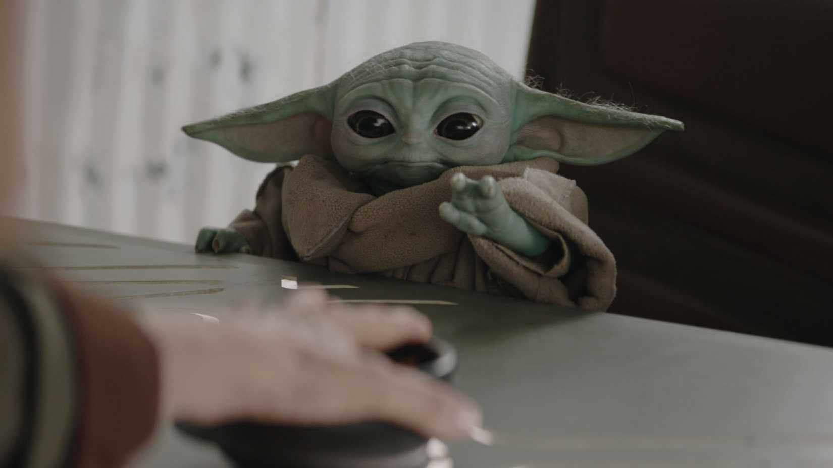 Grogu reaching for a snack in The Mandalorian and Grogu