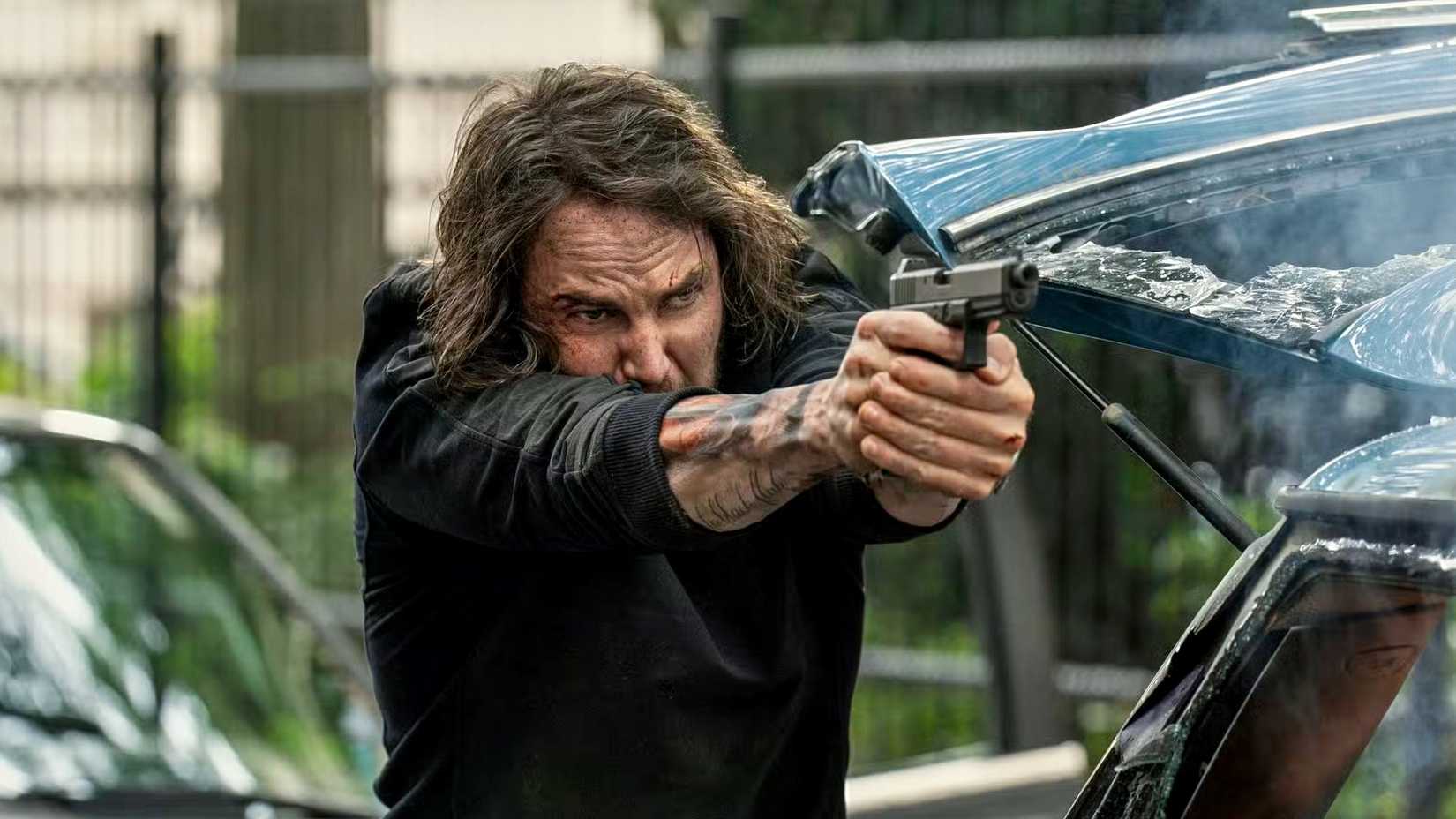 Taylor Kitsch firing a Glock as Ben Edwards in The Terminal List: Dark Wolf