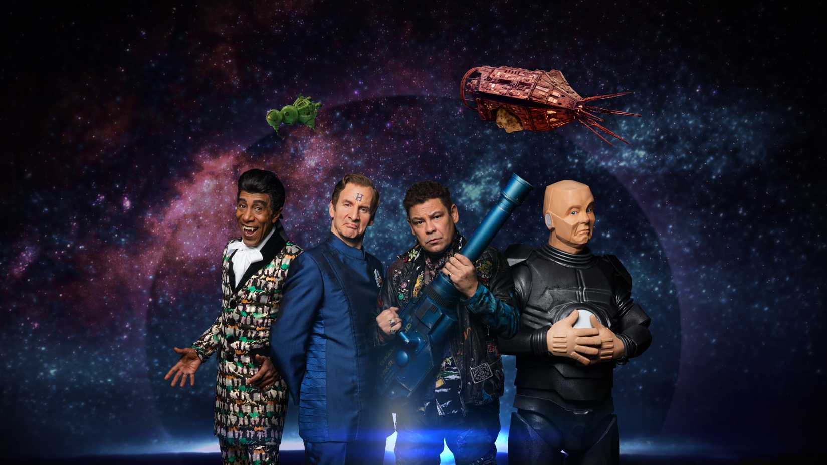 The cast of Red Dwarf is in front of a galaxy