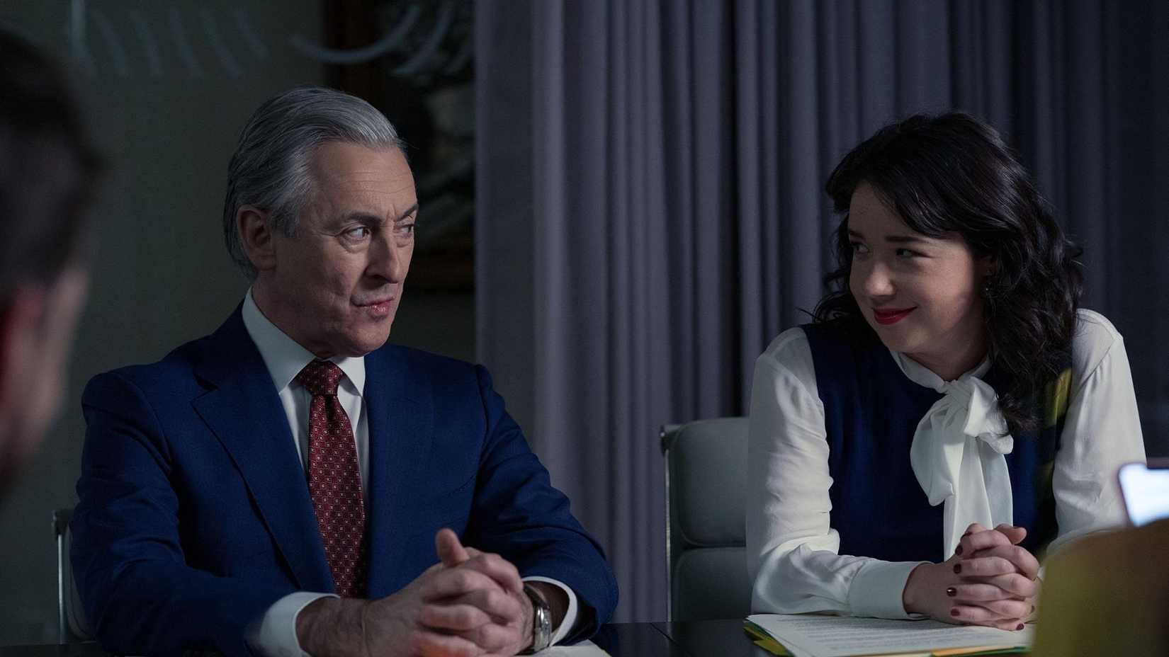 Alan Cumming and Sarah Steele smiling at each other in The Good Fight