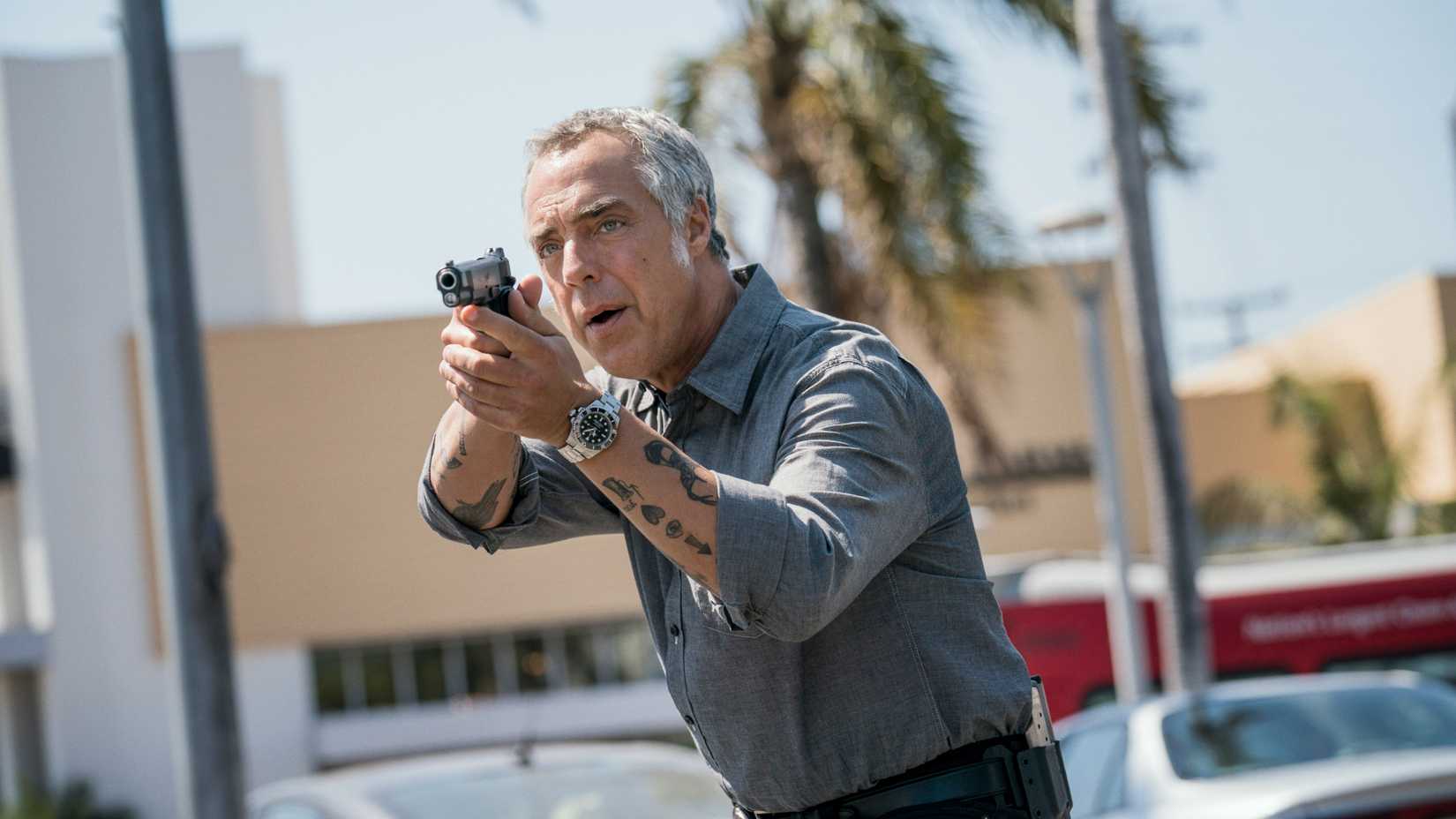 Titus Welliver as Harry Bosch aiming a gun in Bosch