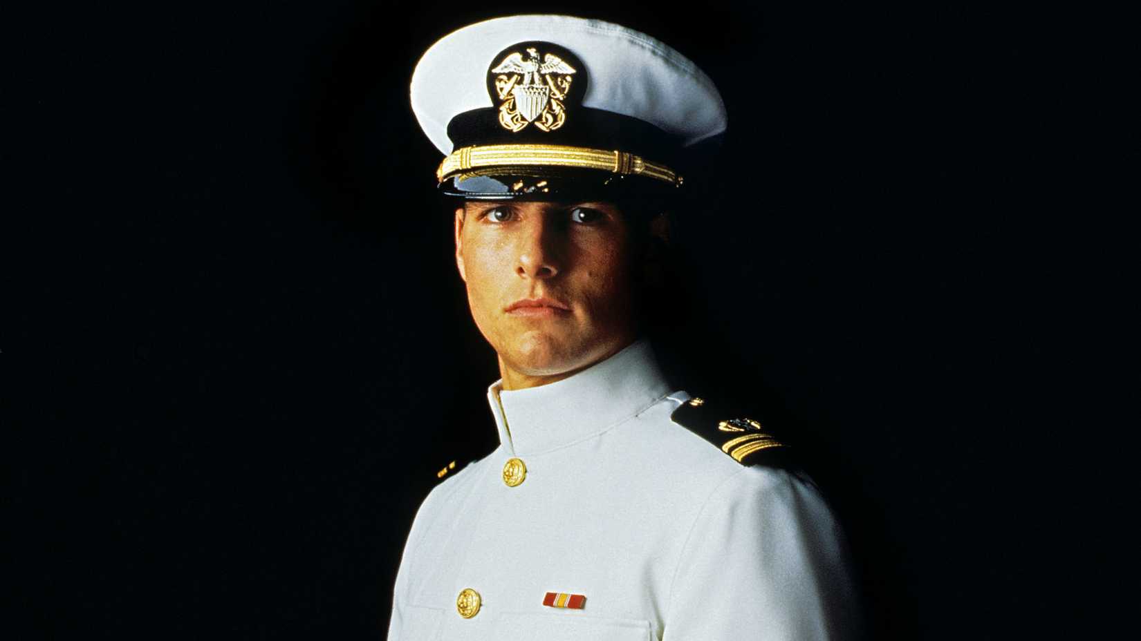 Tom Cruise looks straight ahead with a dramatic expression in a scene from A Few Good Men