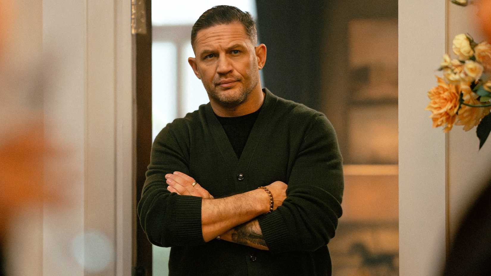 Tom Hardy with his arms folding in Mobland episode 9