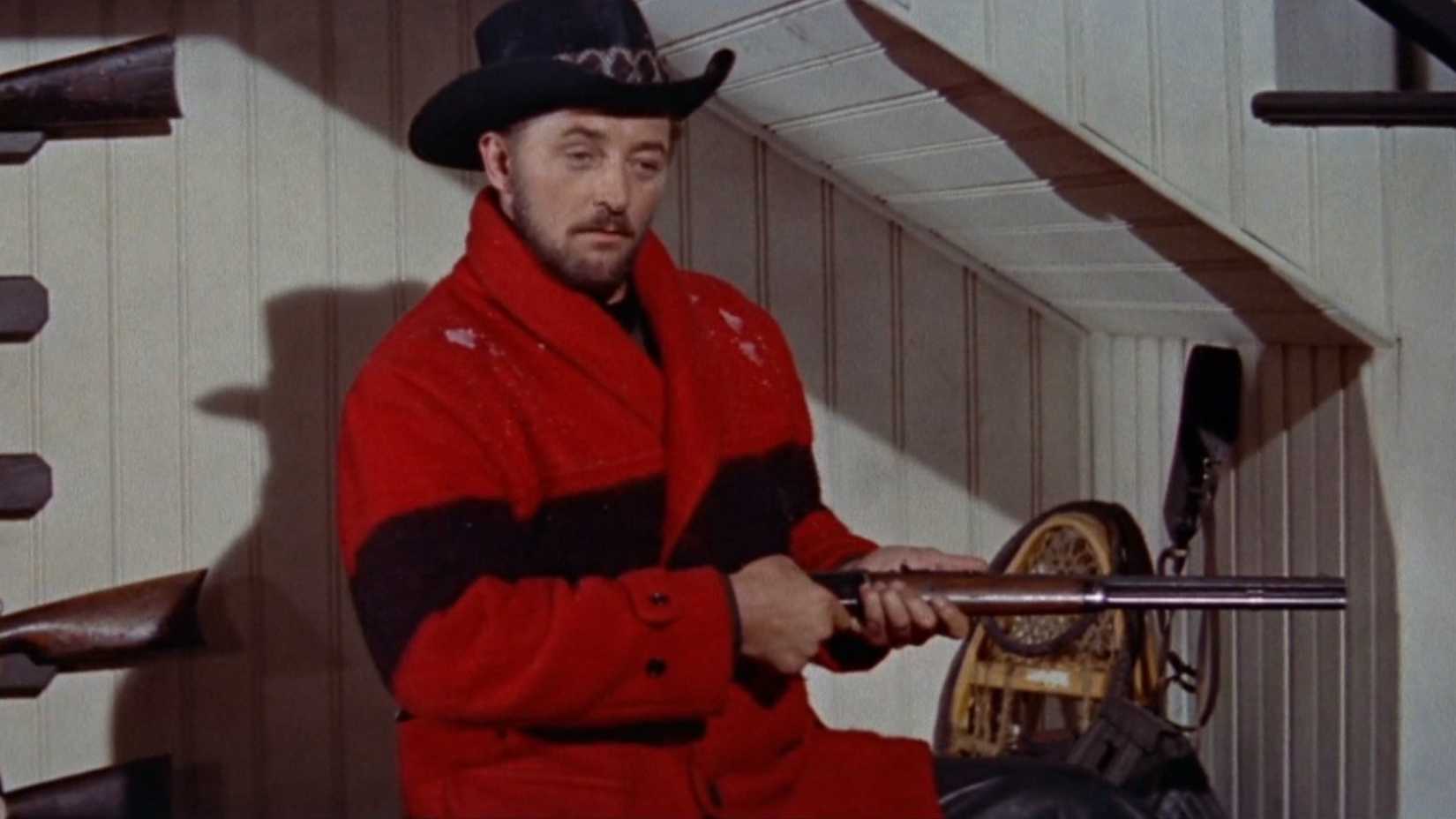 Robert Mitchum holds a rifle in Track of the Cat