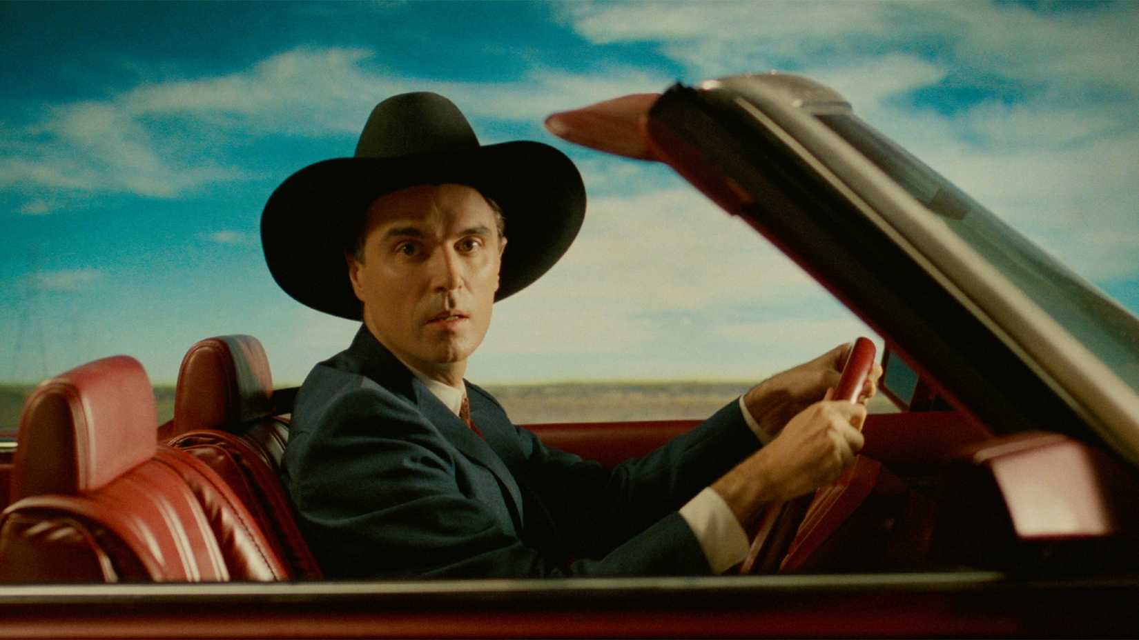 David Byrne talks to the camera while driving in True Stories