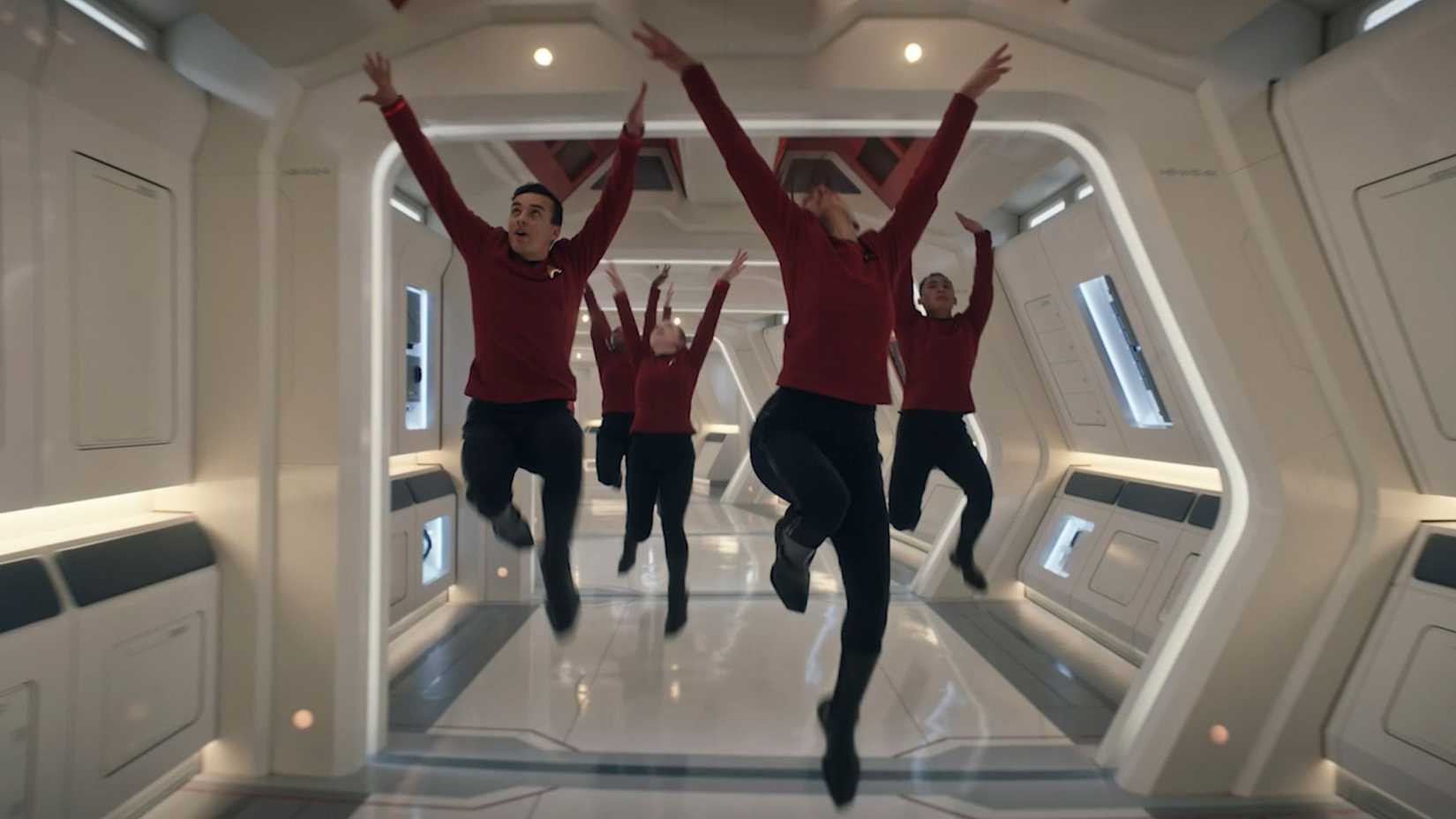 Characters dancing through a spaceship hallway