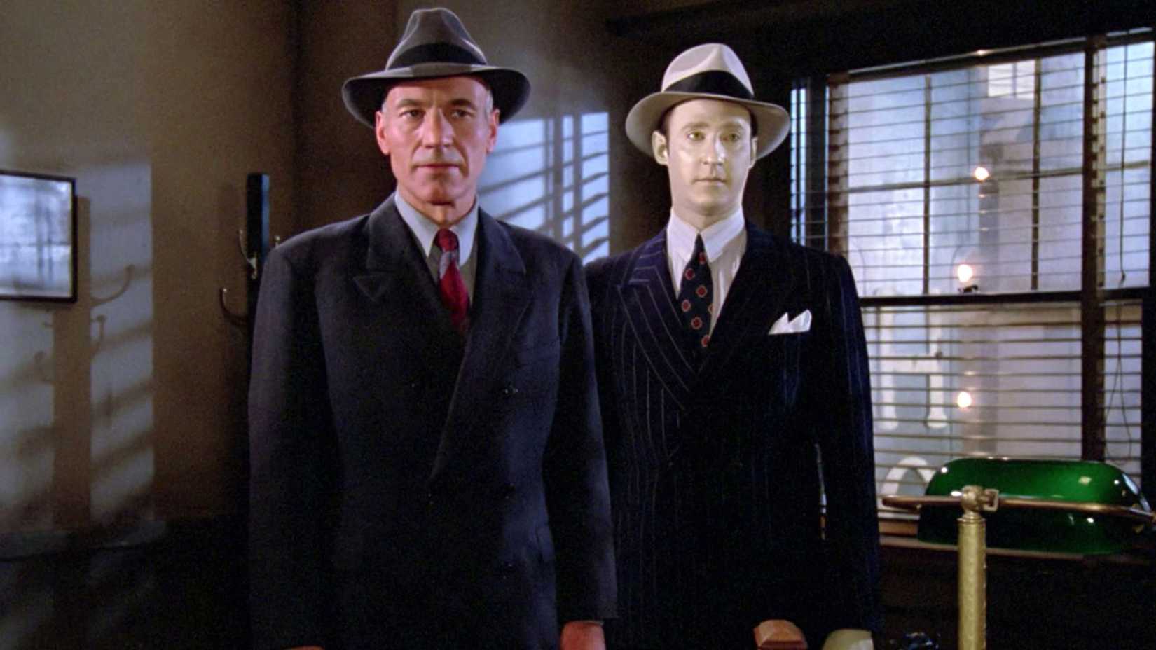 Picard and Data standing in an office while wearing suits