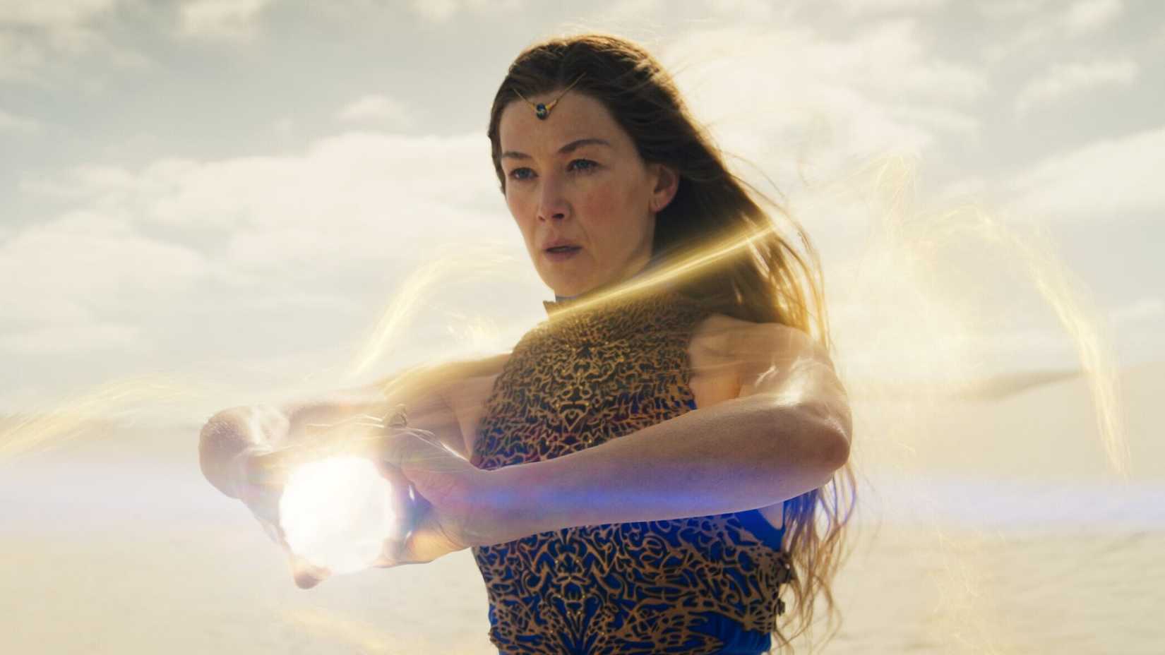 Rosamund Pike holding a glowing orb in The Wheel of Time