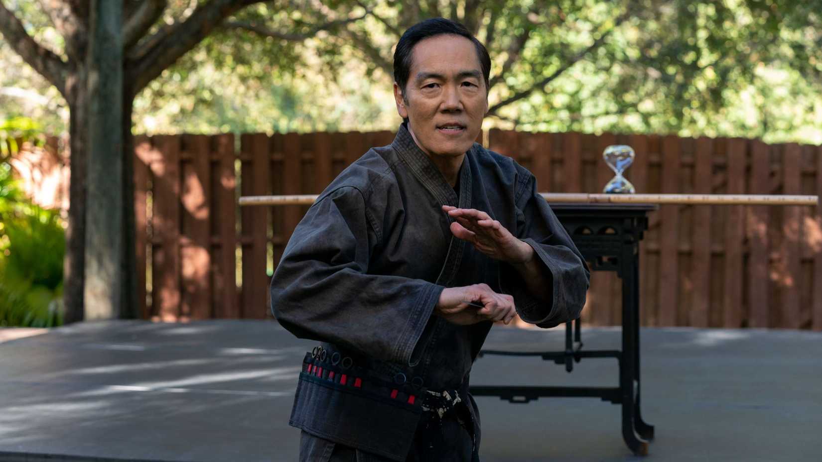Yuji Okumoto as Chozen Toguchi wearing a grey gi