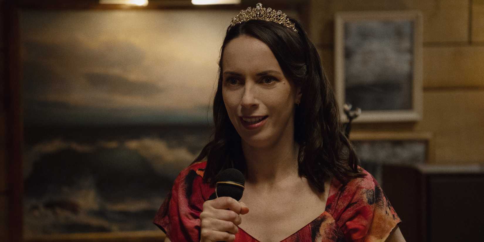 Patricia speaking into a microphone in Widow's Bay